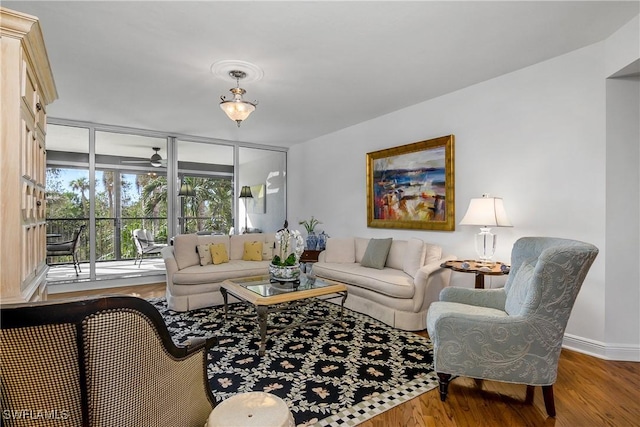 living room with hardwood / wood-style floors and floor to ceiling windows