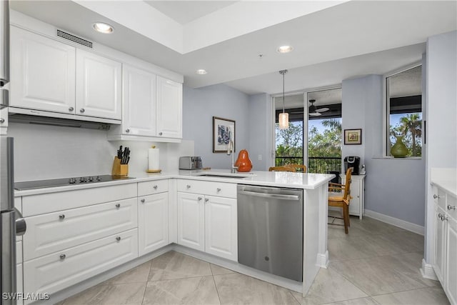 kitchen with sink, stainless steel dishwasher, kitchen peninsula, black electric stovetop, and white cabinets