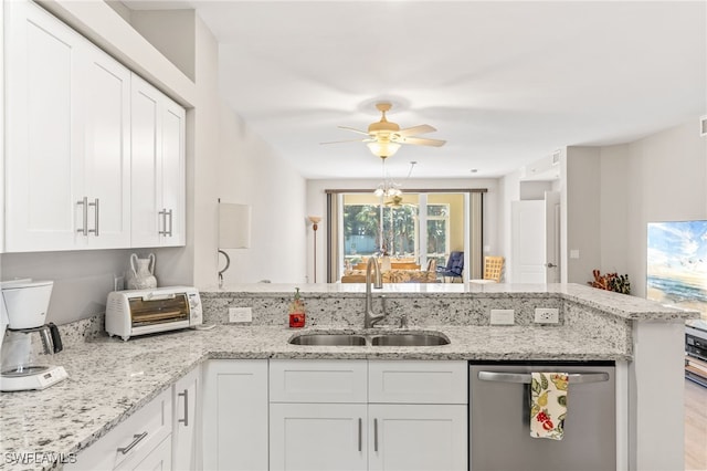 11021 Gulf Reflections Dr Unit 103, Fort Myers, FL 33908 - kitchen featuring a sink, a peninsula, white cabinetry, stainless steel dishwasher, and a toaster