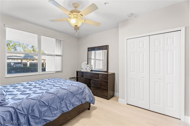 11021 Gulf Reflections Dr Unit 103, Fort Myers, FL 33908 - bedroom with a closet, light wood-style flooring, ceiling fan, and baseboards