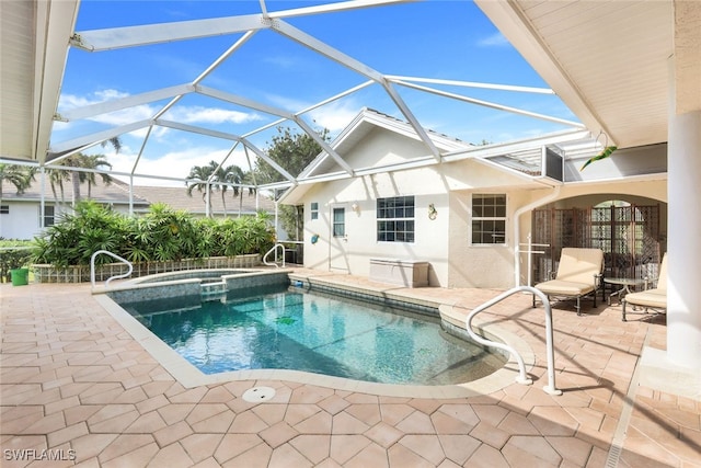 view of swimming pool with an in ground hot tub, a patio area, and a lanai