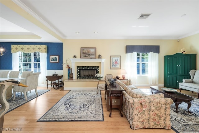 living room with light hardwood / wood-style floors and crown molding