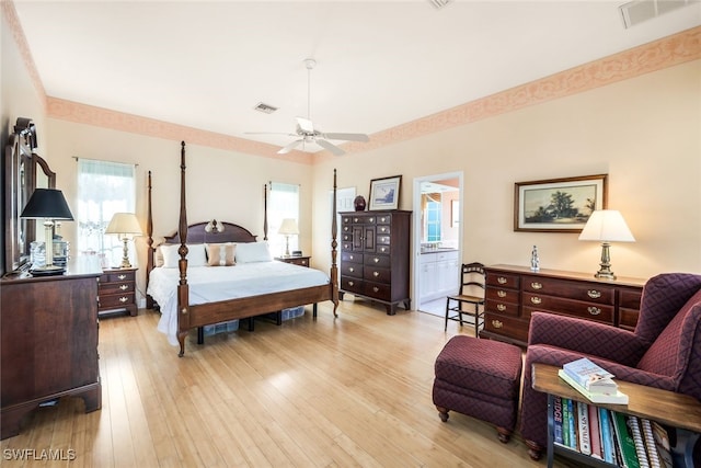 bedroom featuring ensuite bath, ceiling fan, and light hardwood / wood-style floors