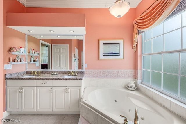 bathroom featuring tiled bath, tile patterned flooring, vanity, and a healthy amount of sunlight