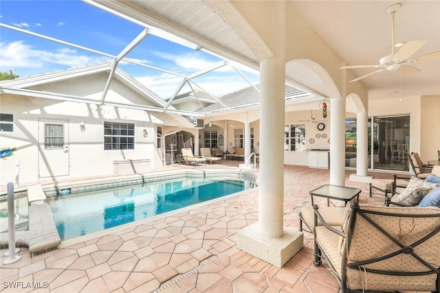 view of swimming pool featuring a lanai, ceiling fan, and a patio