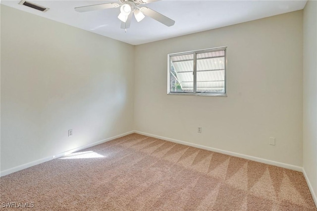 spare room featuring carpet flooring and ceiling fan