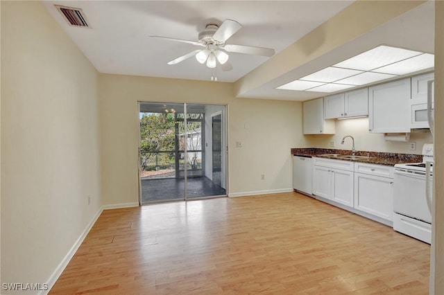 kitchen with white appliances, light hardwood / wood-style floors, ceiling fan, and sink