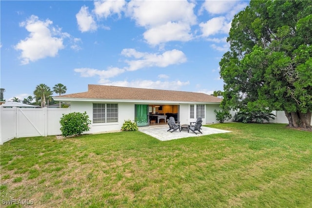 back of property with a patio and a lawn