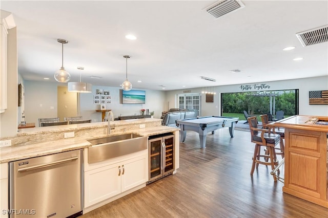 kitchen with sink, dishwasher, beverage cooler, wood-type flooring, and pool table