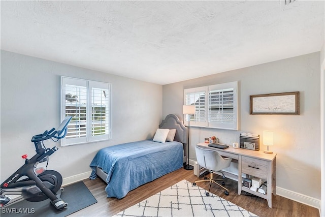 bedroom with hardwood / wood-style floors