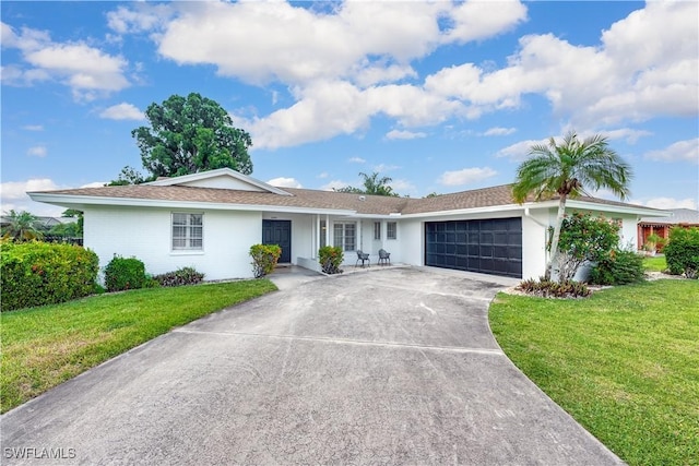 single story home featuring a garage and a front lawn