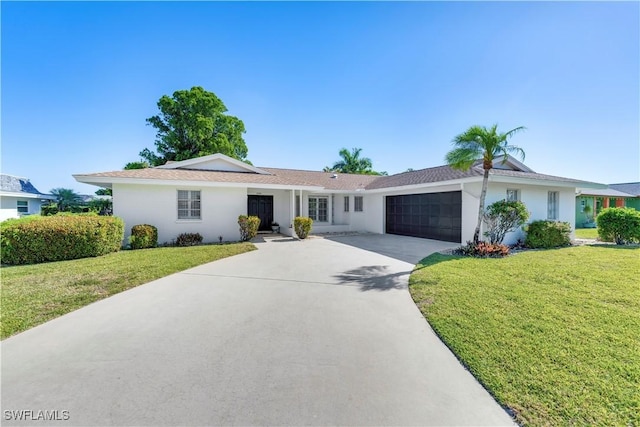 ranch-style house with a front lawn, stucco siding, a garage, and concrete driveway