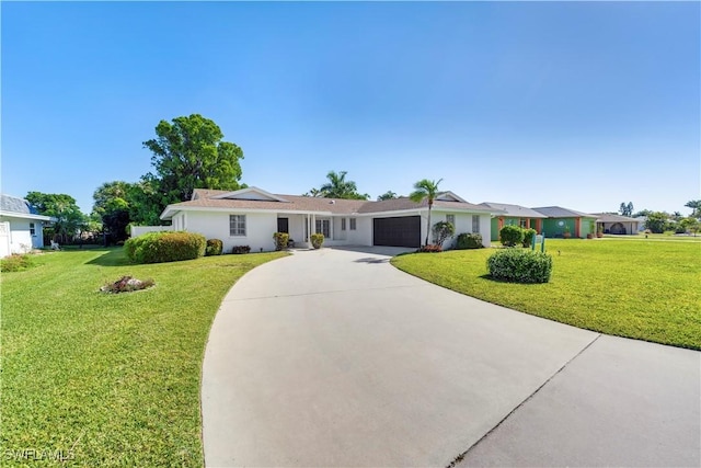 ranch-style home with a garage, driveway, stucco siding, and a front lawn