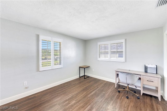 office space featuring visible vents, baseboards, a textured ceiling, and wood finished floors