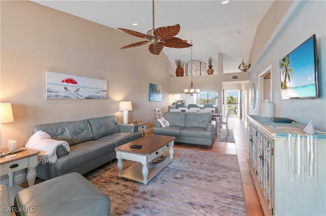 living room with ceiling fan with notable chandelier, light tile patterned floors, and high vaulted ceiling