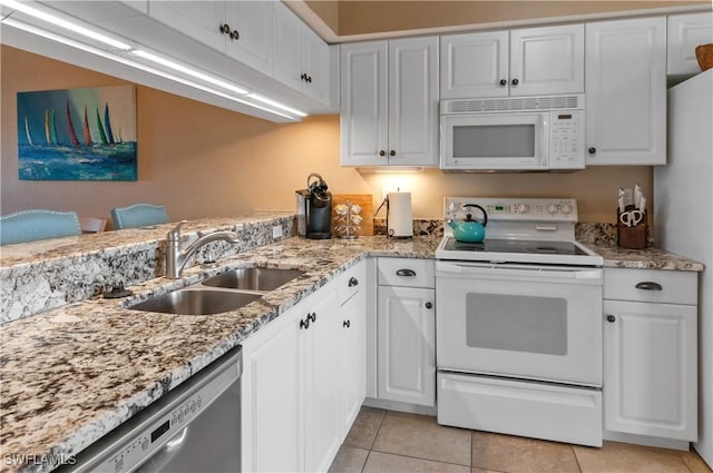 kitchen with sink, white cabinets, and white appliances