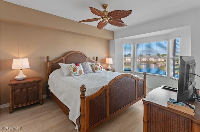 bedroom with ceiling fan and light hardwood / wood-style floors