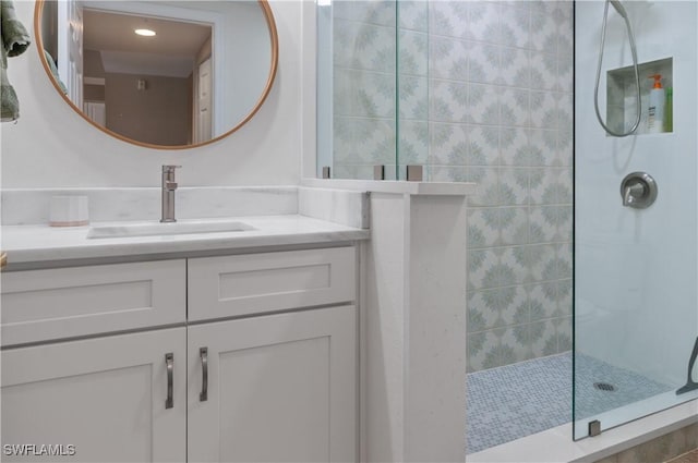 bathroom featuring a shower and vanity