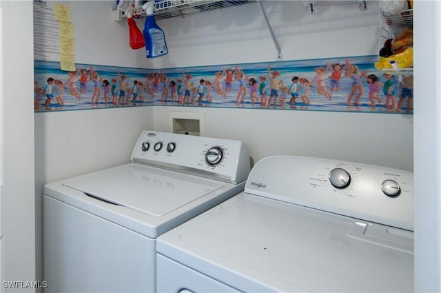 clothes washing area with separate washer and dryer