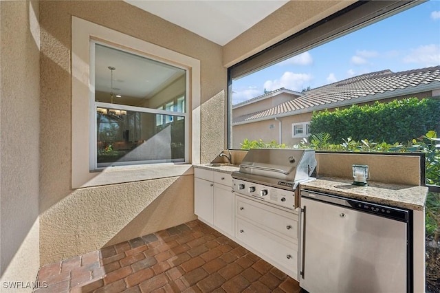 view of patio / terrace with grilling area, sink, and exterior kitchen