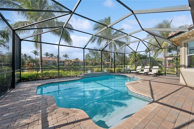 view of swimming pool featuring glass enclosure and a patio