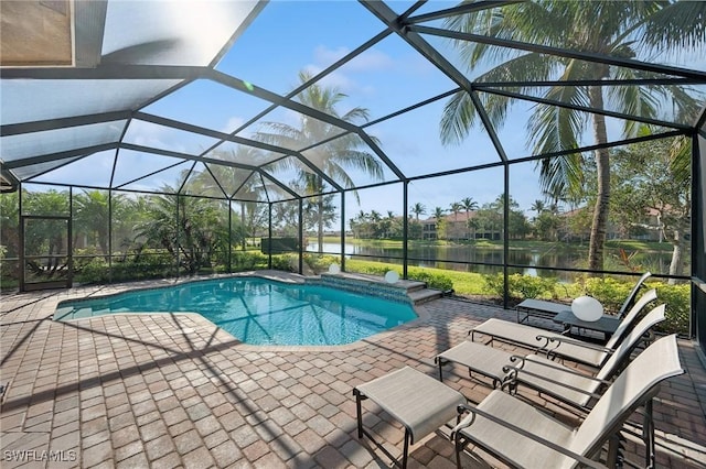 view of swimming pool with a lanai, a water view, and a patio