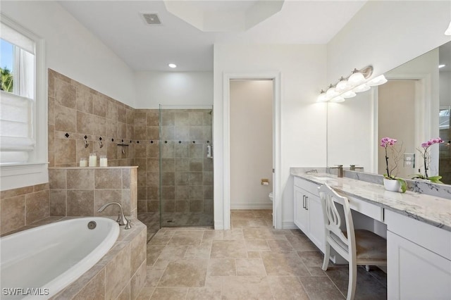 full bathroom featuring separate shower and tub, vanity, and toilet