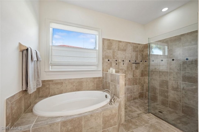 bathroom featuring tile patterned flooring and shower with separate bathtub