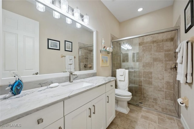 bathroom with vanity, toilet, and an enclosed shower