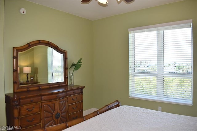 bedroom featuring multiple windows and ceiling fan