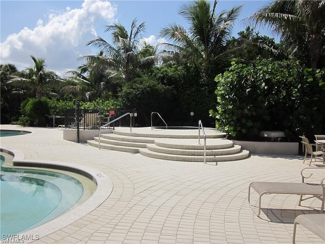 view of swimming pool featuring a patio area