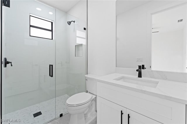 bathroom featuring an enclosed shower, vanity, and toilet