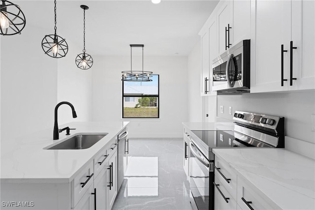 kitchen featuring light stone counters, stainless steel appliances, sink, white cabinets, and hanging light fixtures