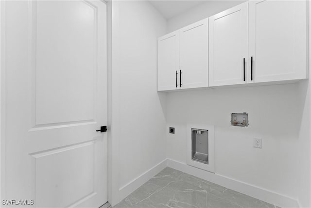 washroom with cabinets, hookup for a washing machine, and hookup for an electric dryer