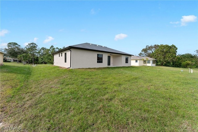 back of property featuring a yard