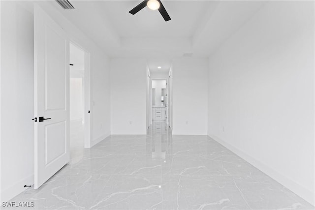 unfurnished room featuring a tray ceiling and ceiling fan