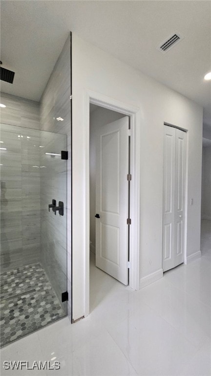 bathroom featuring tile patterned flooring and walk in shower