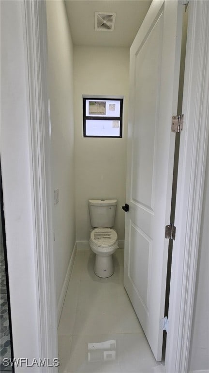 bathroom with tile patterned flooring and toilet