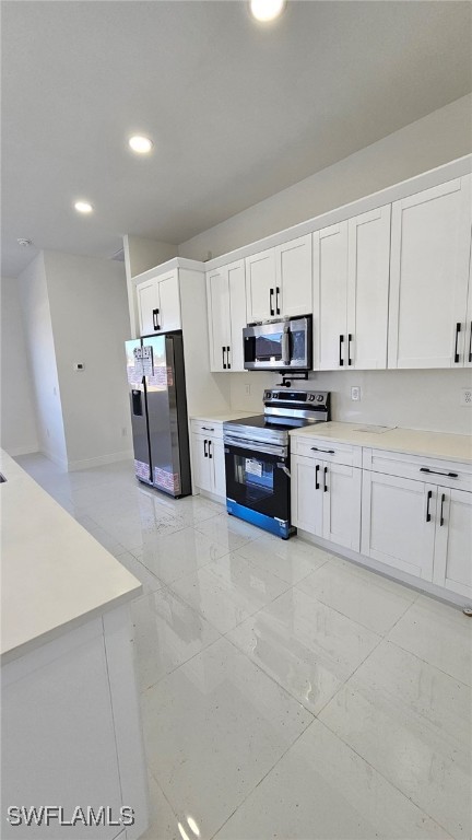 kitchen with white cabinetry and appliances with stainless steel finishes