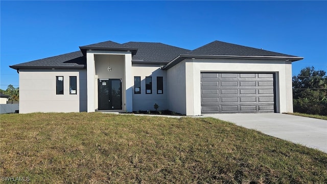 view of front of property with a front yard and a garage