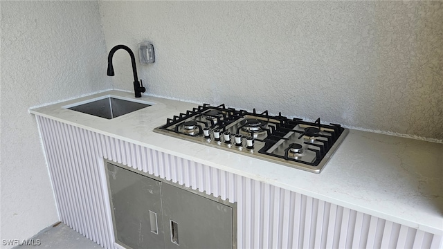 room details with stainless steel gas stovetop and sink