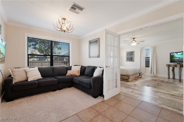 living room featuring ceiling fan with notable chandelier, ornamental molding, french doors, and light hardwood / wood-style flooring