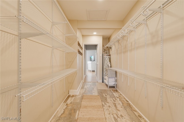 spacious closet featuring light hardwood / wood-style floors