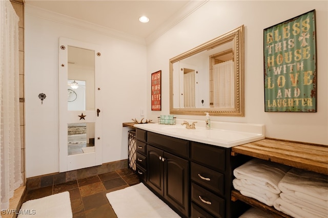 bathroom featuring crown molding and vanity