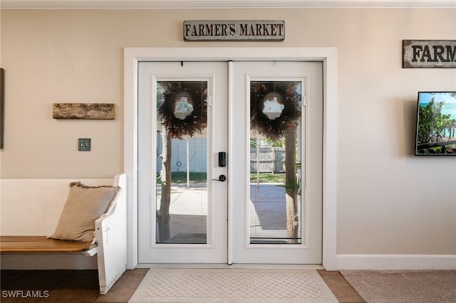 doorway with light tile patterned flooring