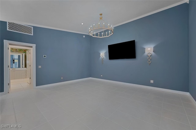 tiled spare room featuring an inviting chandelier and ornamental molding