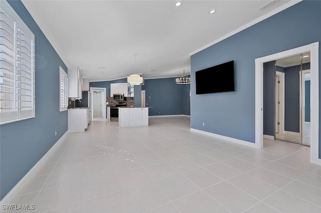 unfurnished living room featuring sink, an inviting chandelier, light tile patterned flooring, and ornamental molding