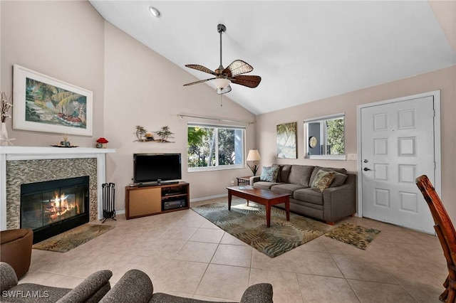 living room with ceiling fan, a wealth of natural light, light tile patterned floors, and high vaulted ceiling