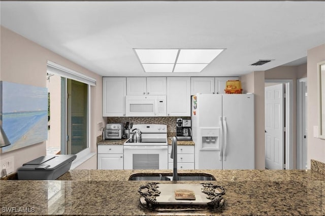 kitchen featuring white appliances, white cabinets, sink, tasteful backsplash, and stone countertops