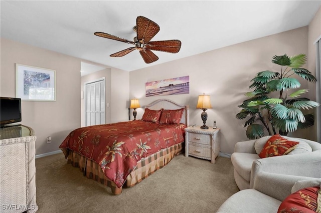 carpeted bedroom featuring ceiling fan and a closet